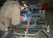 Mark makes repairs to a kart frame